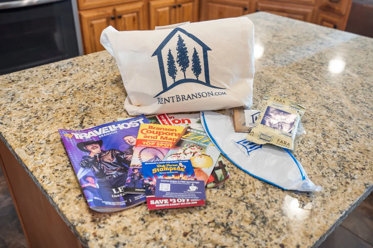 The image depicts a tote bag with a logo, magazines, and snacks arranged on a table, suggesting thoughtful amenities for guests. The welcoming mood captures the preparations for exploring local attractions and planning activities.