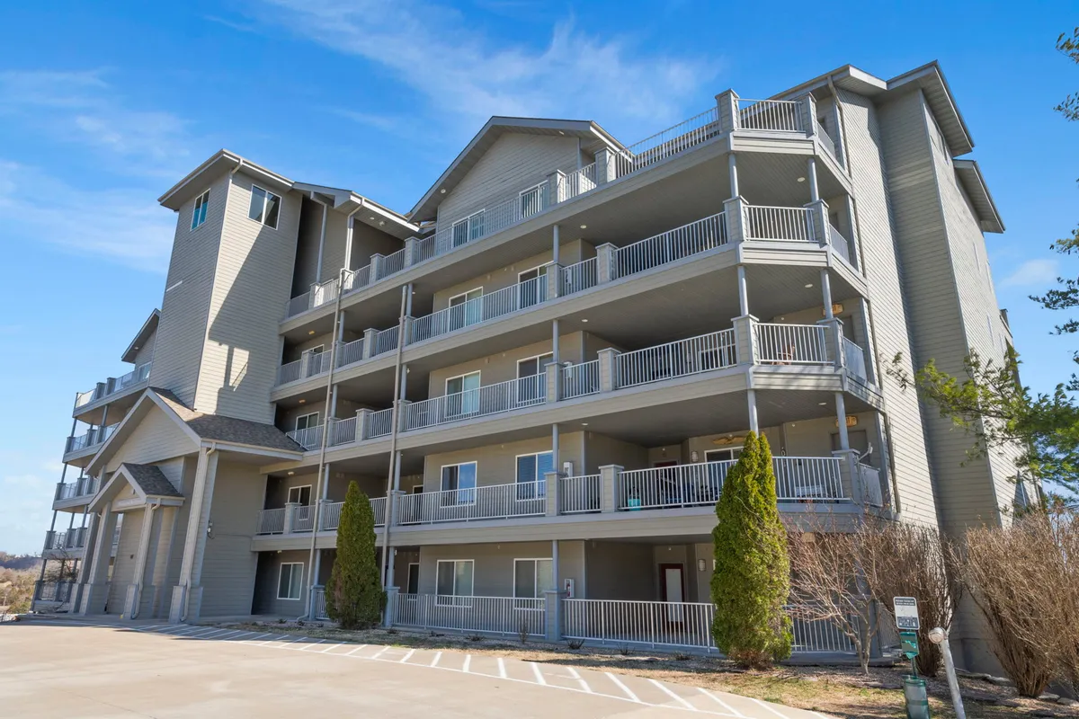 This exterior shot captures the building's balconies and large windows, emphasizing spaces for relaxing outdoors or enjoying the view. The architecture is welcoming, with plenty of opportunities to connect with the surrounding landscape.